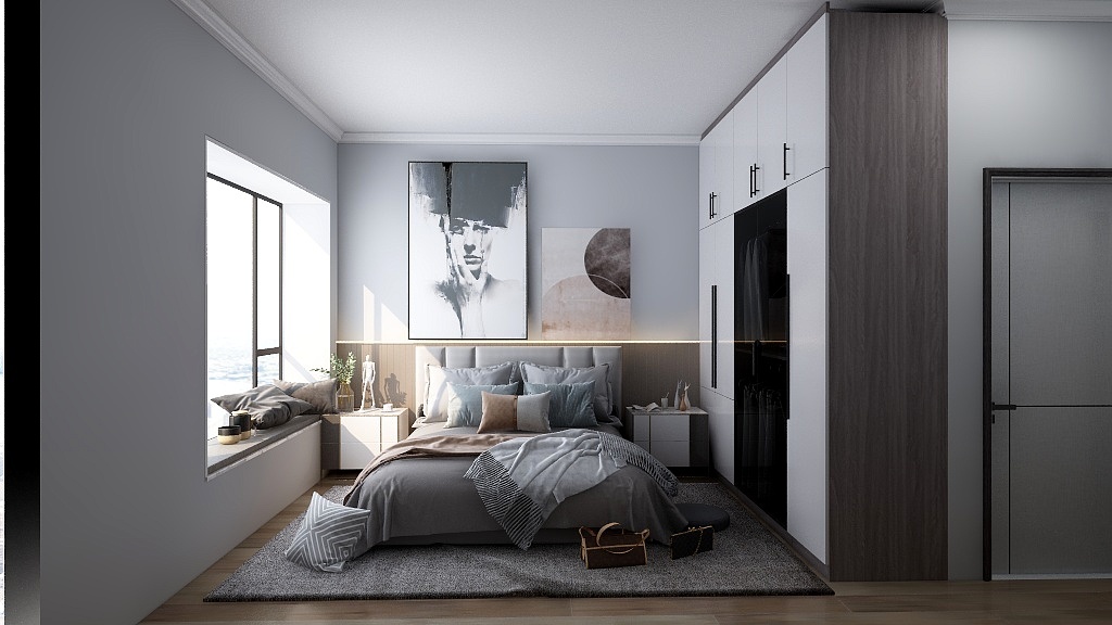 这是一个卧室空间，整体以灰色和白色为主色调，显得简洁而优雅。墙面是浅灰色的，与白色的衣柜门形成对比，增添了一些现代感。